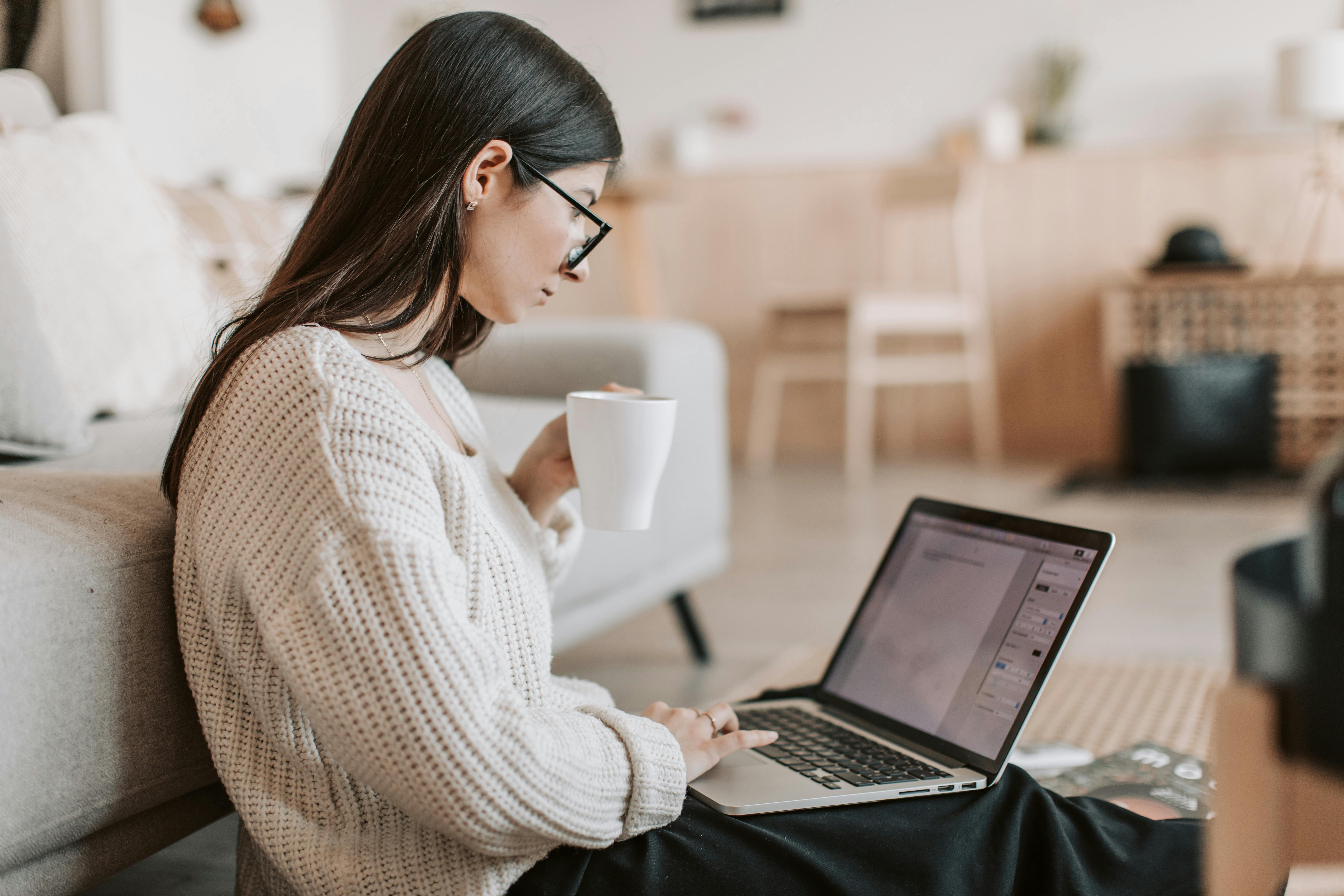 Writer analyzing data with coffee beside laptop